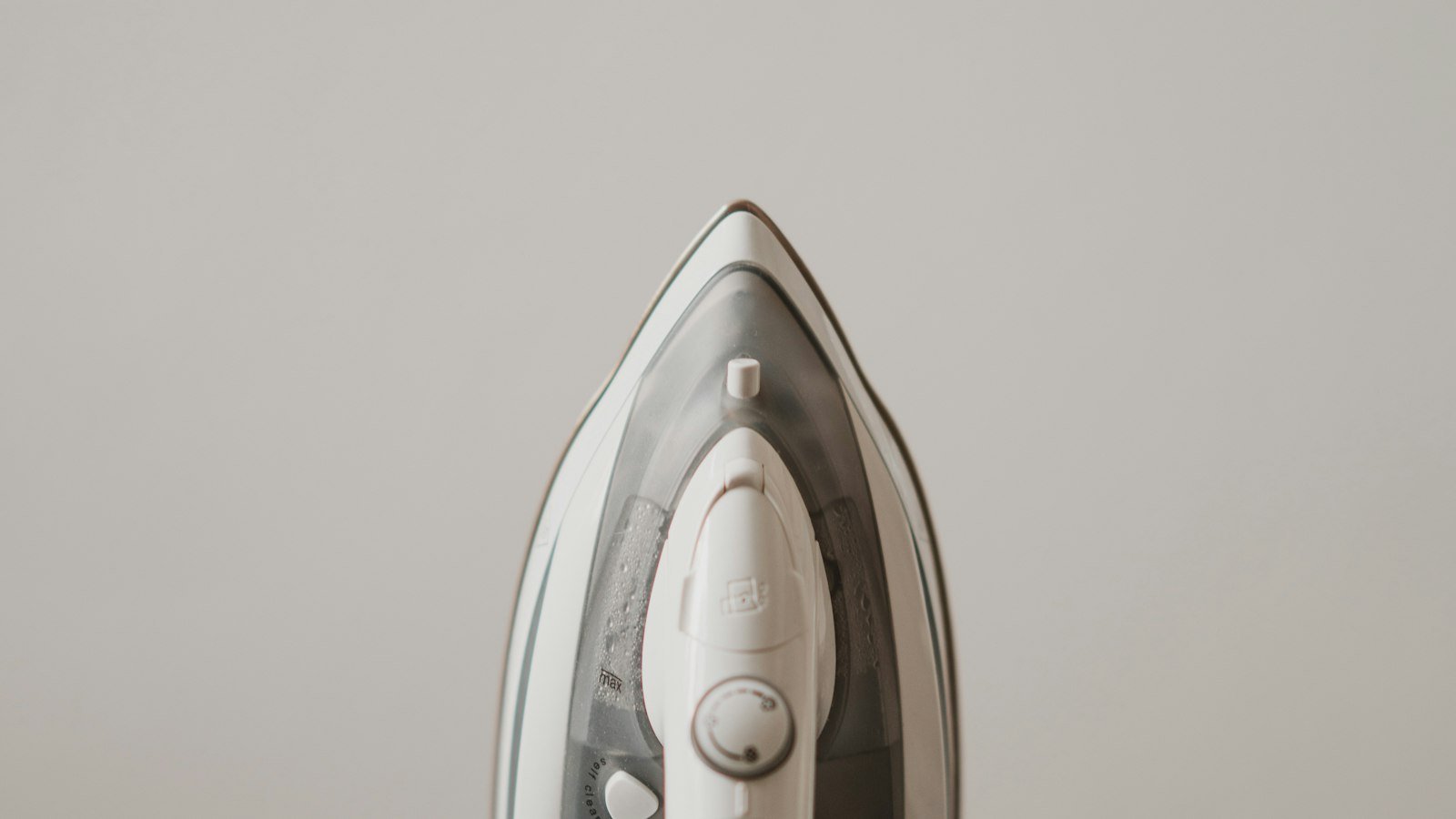A steam iron on a plain background