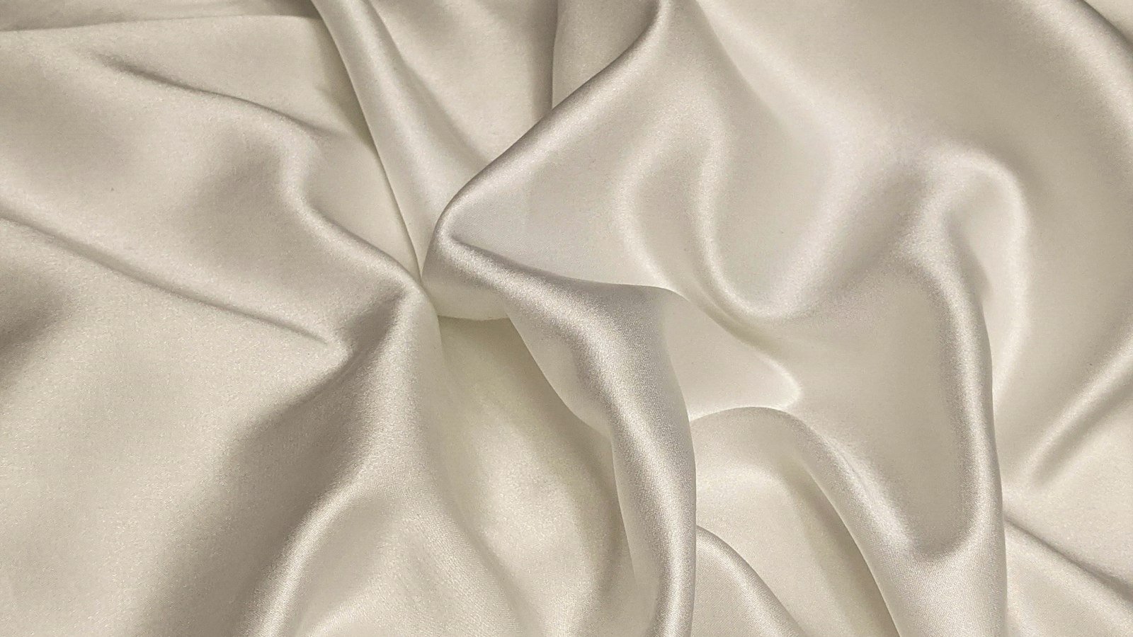 Soft folds of cream silk fabric